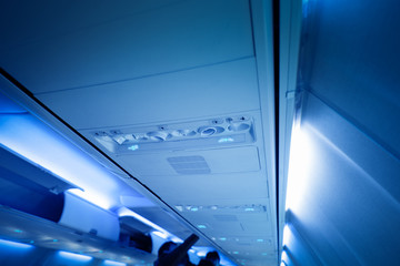 Fototapeta premium Cabin inside the aircraft, lights, air condition and signs panel above the seat