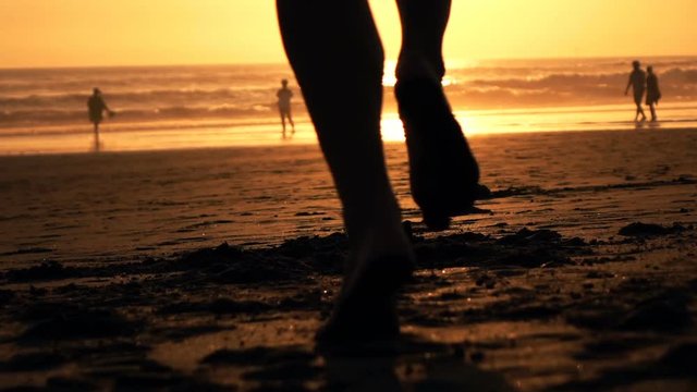 Man jogging on beach during sunset, super slow motion 240fps
