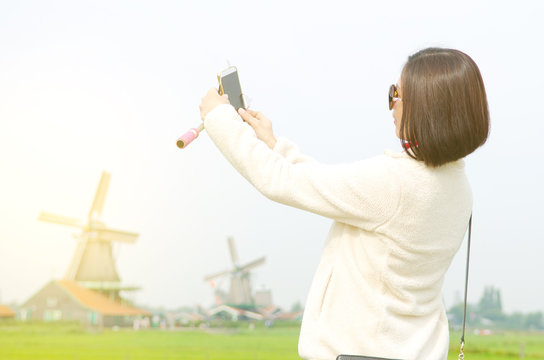 Woman taking selfie in Zaanse Schans, Netherlands