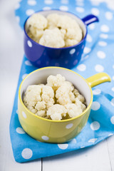 Boiled cauliflower in multi-colored bowls