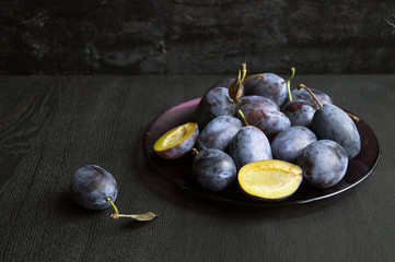 Plums on a black background.
