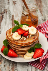 Pancakes with strawberries and bananas