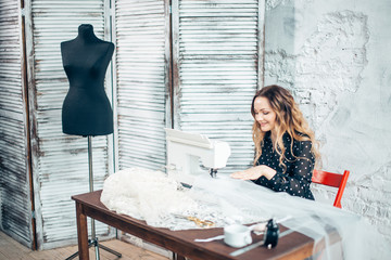 Tailor working in the shop using industrial grade tailoring machine