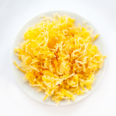 Heap of grated cheese  isolated on white background, macro image top view image.