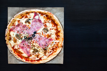 Meat Pizza with Ham, Pepperoni and Bacon on a black background