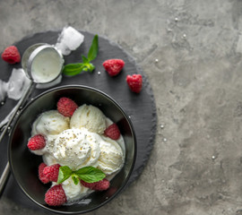 ice cream with raspberries served in black piala