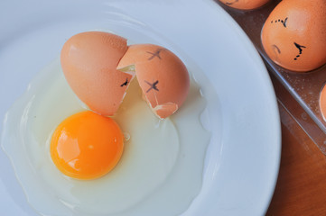 brown eggs face crying arranged in carton