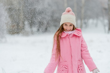 Smiling girl in whirl of snowflakes