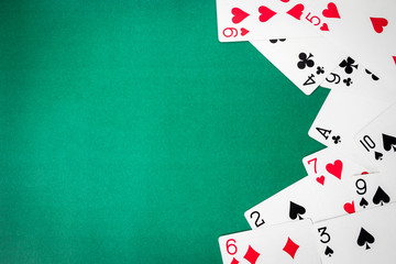 Playing cards on green background. Free space for text