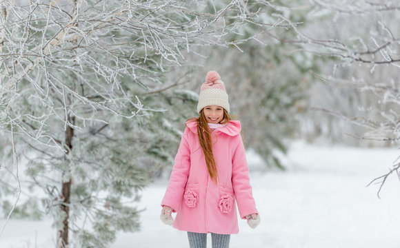 Girl in pink coat enjoying being outside