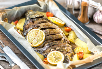 Delicious baked fish with lemons, spices