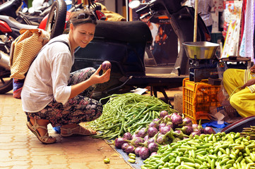 Young woman choosing vegetables