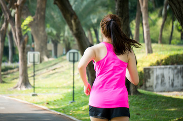 Asian sport woman running / jogging in park for health