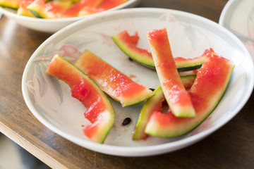 after meal, peel of a watermelon on a plate