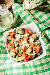Broad bean salad with tomatoes, onion and olive