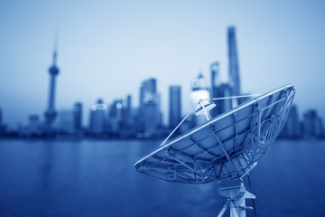 In the city night background large satellite antenna