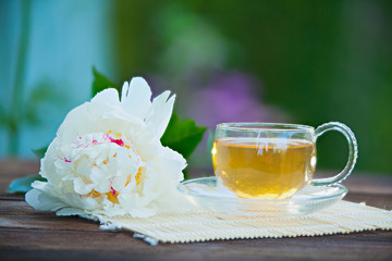 Crystal cup with green tea on table