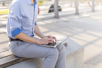 Man Businessman Freelancer working on his laptop outdoors