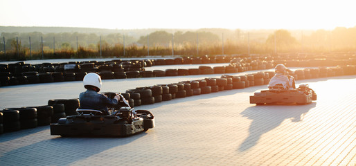 Karting competition or racing cars riding for victory on a racetrack