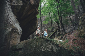 Romantic newlywed couple walking by country side in mountains