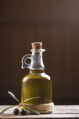 Olive oil and olives on wooden rustic table
