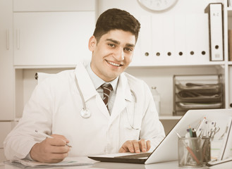 Professional doctor is doing report about patients