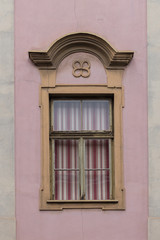 Elegant, decorated window with red and white striped blinds pulled down