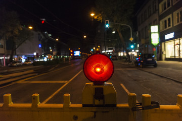 Fence with red warning light warning of construction