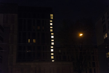 Fototapeta na wymiar Building at night with lighted windows