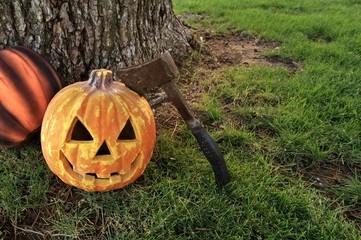 Halloween background featuring a creepy jack o lantern under a tree.