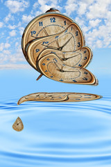 Liquid and flexible time concept.Surreal Alarm clock transforming and thawing in blue water ripples.