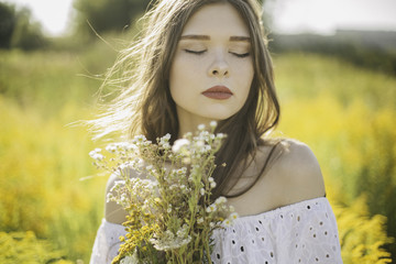 Young girl in a field of yellow flowers
