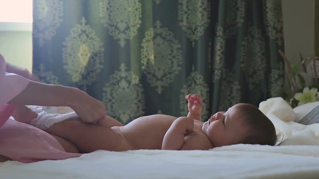 Mom Puts the child in diapers