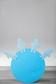 Blue paper cut out figures on circle