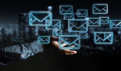Businessman holding and touching floating emails 3D rendering