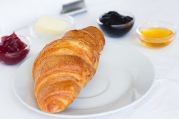 Croissant, jams, butter and honey