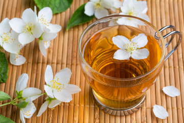 Fototapeta na wymiar Glass cup of tea with jasmine