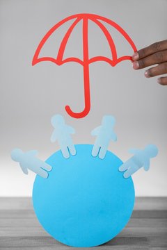 Composite image of hand holding a red umbrella