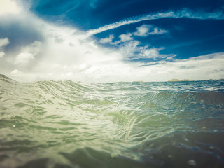 sea or ocean water surface with blue sky and clouds