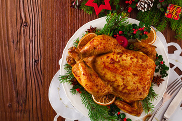 Roasted whole chicken with Christmas decoration.