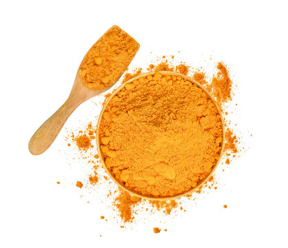 top view of turmeric powder in wooden bowl and spoon isolated on white background