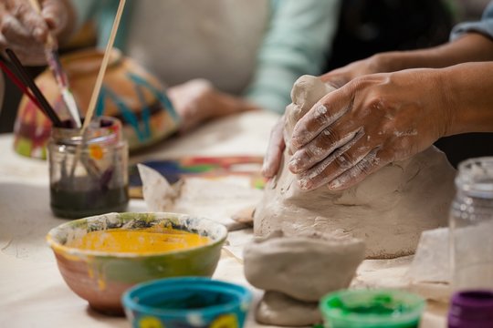 Hand of woman molding clay