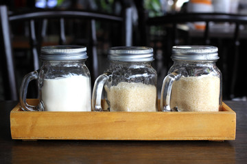 sugar and creamer in glass bottle