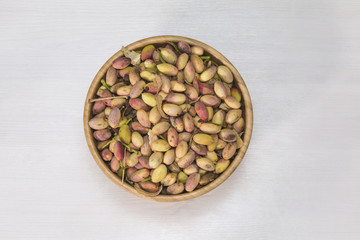 Wooden bowl with fresh pistachio of Bronte..