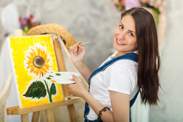 Fototapeta premium Portrait of gorgeous woman artist painting at home