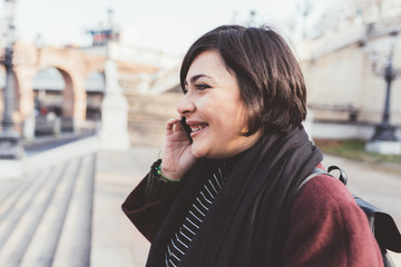 young woman walking outdoor talking smartphone smiling - conversation, communication, happiness...