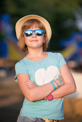 Smiling girl in sunglasses and straw hat