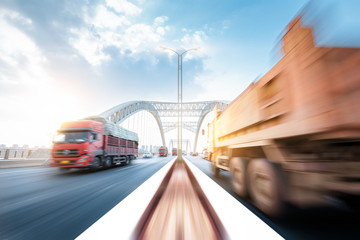 Fototapeta na wymiar truck speeding through a bridge at sunset,motion blur.