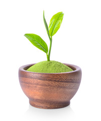 green tea powder and leaf in wood bowl on white background