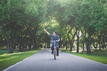Asian man riding bicycles in the park at morning